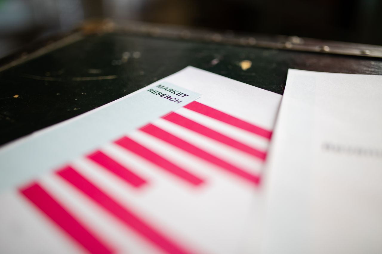 gallery-1 A detailed close-up of a market research document featuring a bar graph and a focus on market trends.